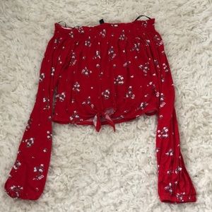 A red cropped long sleeve shirt